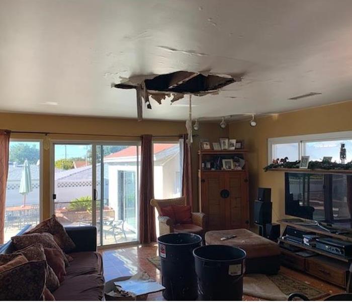 Ceiling partially collapsed due to water damage.